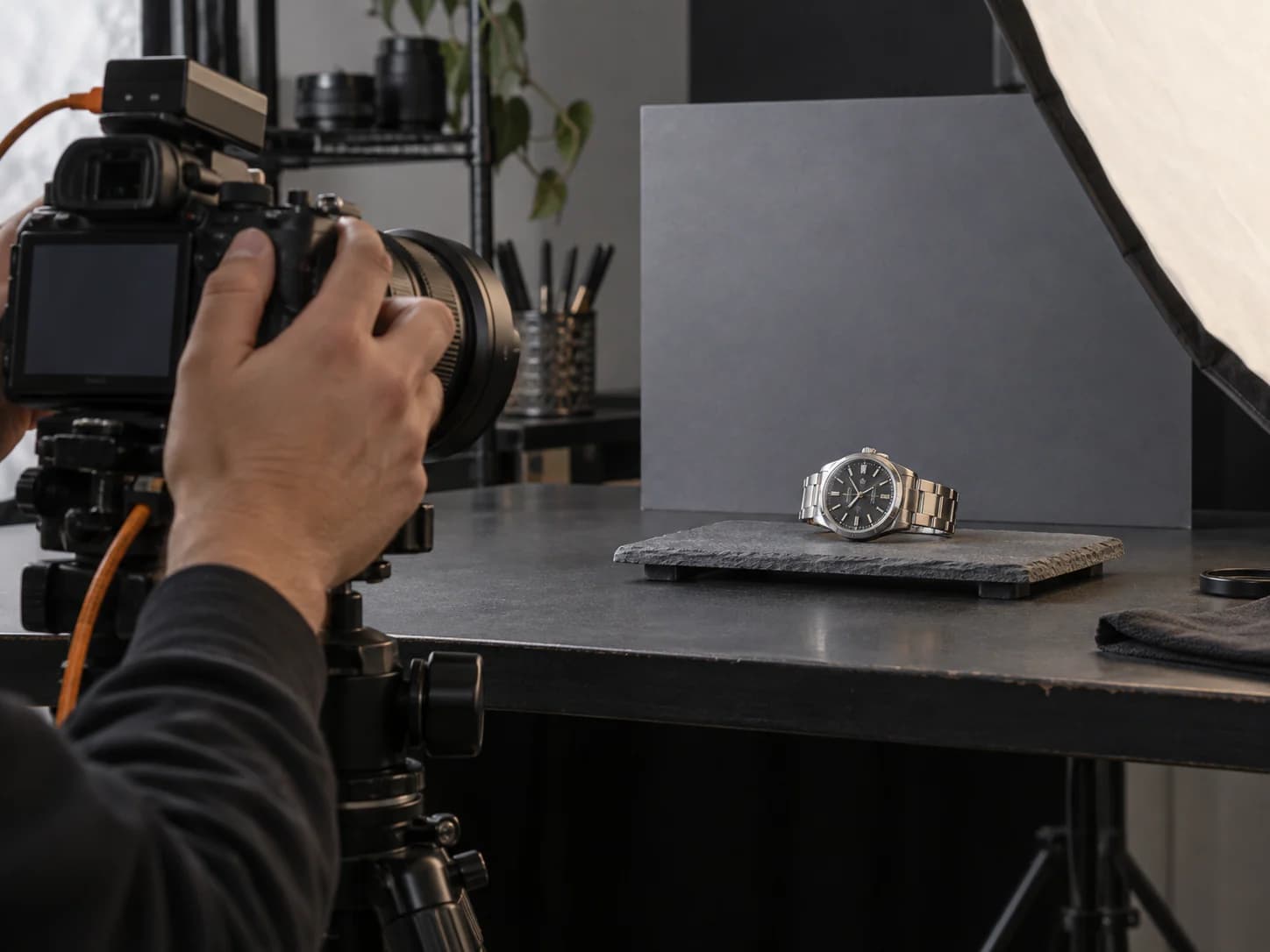 A consigned watch being photographed on the Wristly bench before listing